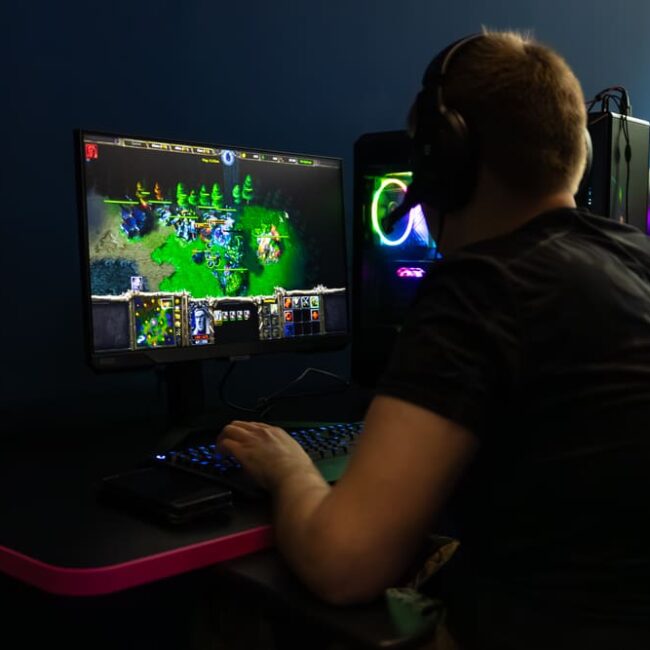 Esports bootcamp image, man on computer playing Warcraft