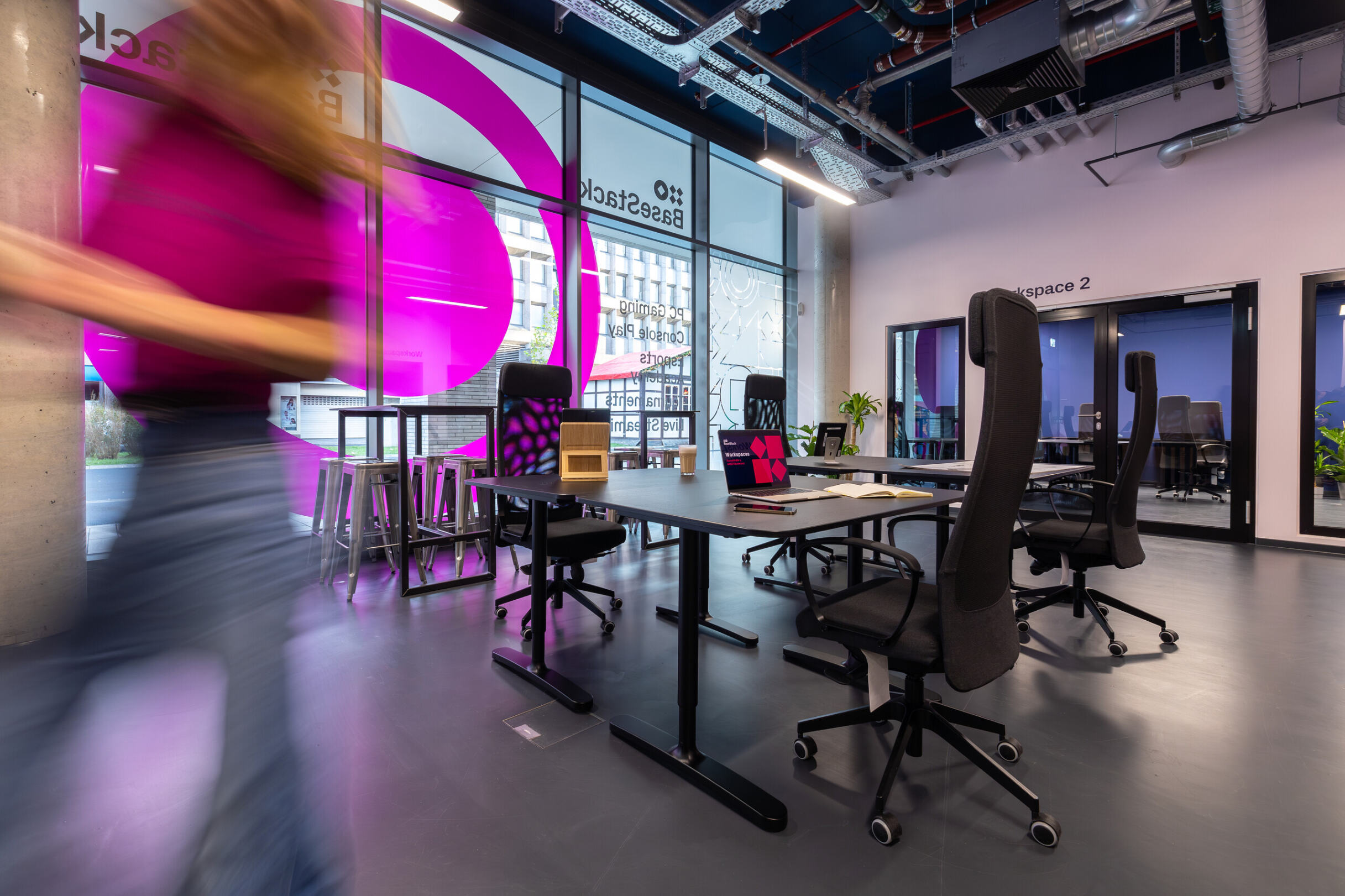 Woman walking out of room. Coworking, hot desk and meeting rooms in central Dortmund.