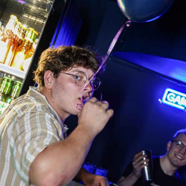 Man partying and doing shots at bar in Dortmund