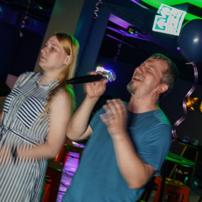 Two people singing at Karaoke bar at BaseStack Dortmund