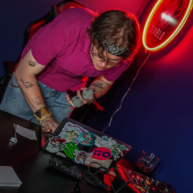 BaseStack employee mixing karaoke songs at bar in Dortmund