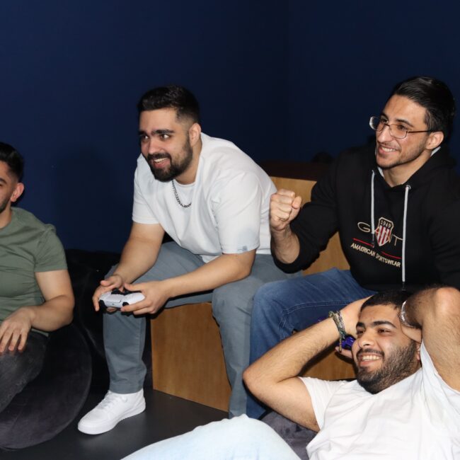 Guys playing Xbox and PS5 consoles in esports cafe in central dortmund