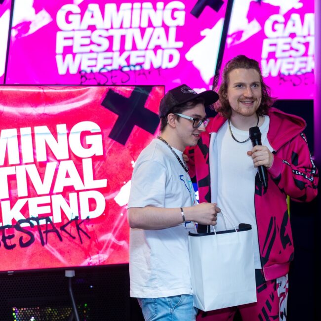 Man giving prize for winning at a panel at Gaming festival Weekend, esports cafe central dortmund, venue hire.