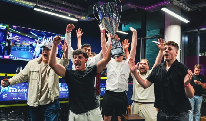 Winning team holding up trophy at BaseStack BREACH event, esports gaming venue in central dortmund