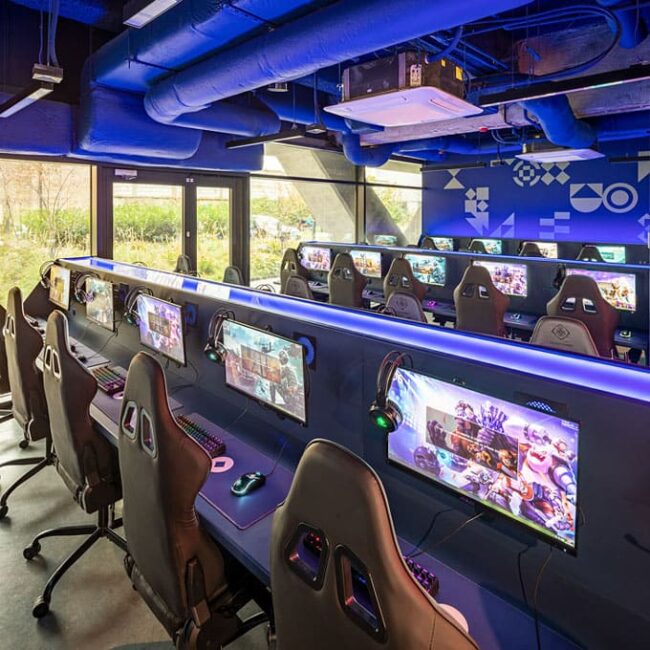Basestack computers showcased with gaming chairs and industrial themed roof.