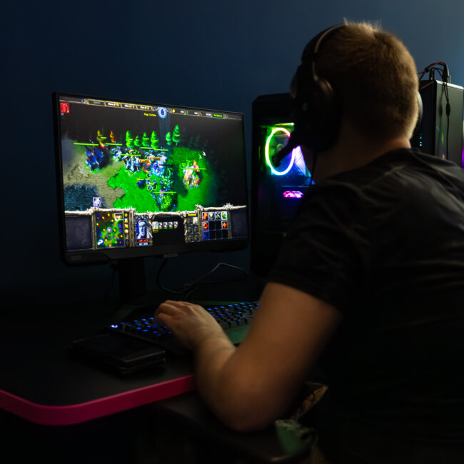 Esports cafe, gaming, man playing Warcraft 3 on PC