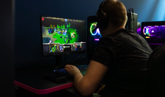 Esports cafe, gaming, man playing Warcraft 3 on PC