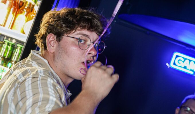 Man drinking a blue shot at Karaoke in Łódź bar at BaseStack