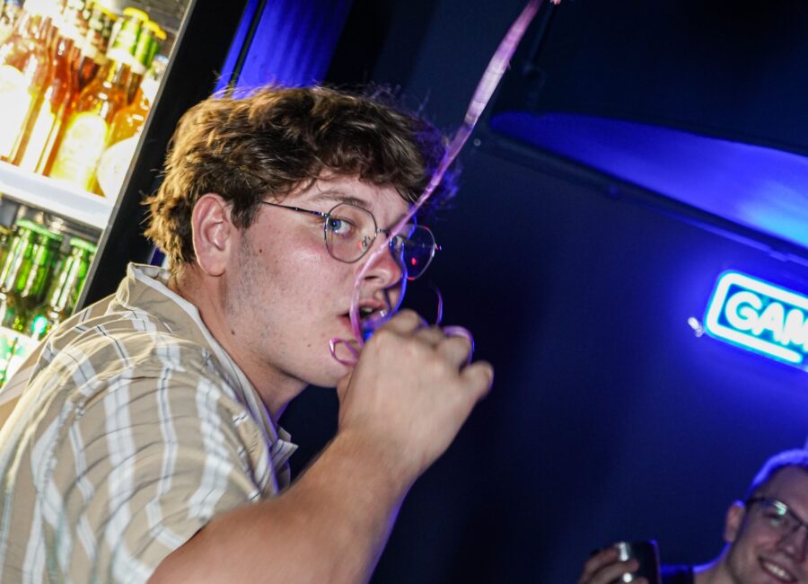 Man drinking a blue shot at Karaoke in Łódź bar at BaseStack